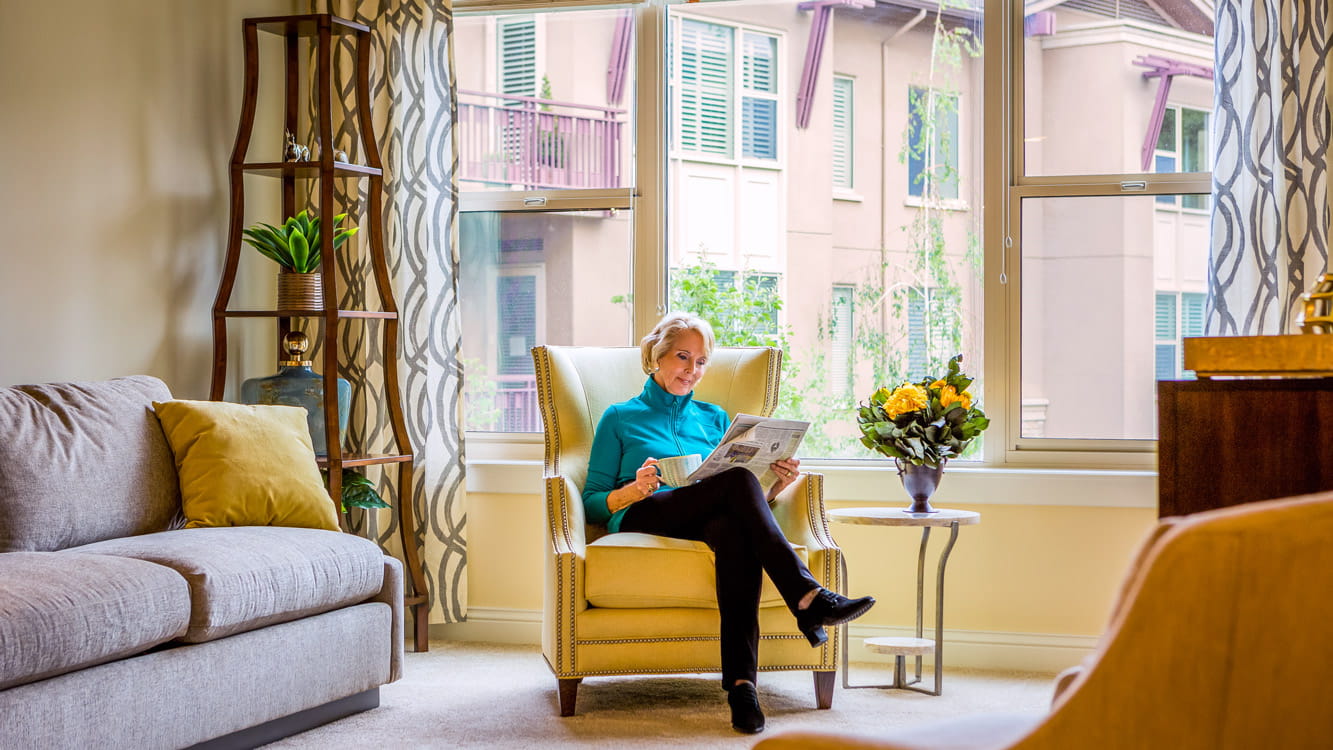 A woman reads in a Mendocino apartment.